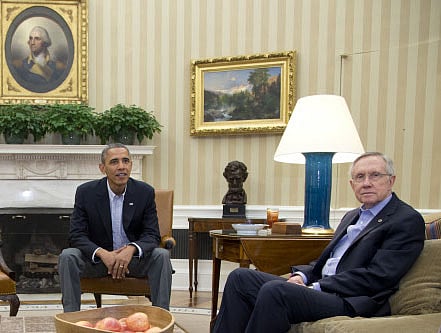 President Barack Obama, left, and Senate Majority Leader Harry Reid of Nev., look to photographers as they meet with Sen. Patty Murray, D-Wash., Sen. Dick Durbin, D-Ill., and Sen. Charles Schumer, D-N.Y., in the Oval Office of the White House, Saturday, Oct. 12, 2013, in Washington. The federal government remains partially shut down and faces a first-ever default between Oct. 17 and the end of the month. AP photo