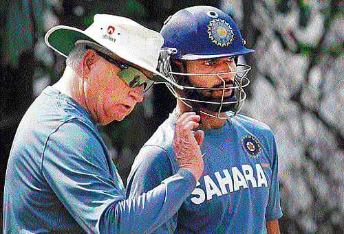 keep it simple: Indian coach Duncan Fletcher (left) discusses a point with Shikhar Dhawan during a practice session at the Punjab Cricket Association stadium on Friday. pti