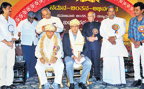 Speaker Kagodu Thimmappa felicitates writer Dr Chandrashekhara Kambara and former cricketer Anil Kumble at the valedictory of former chief minister S Bangarappa's birth anniversary celebrations at the Palace Grounds in Bangalore on Monday. (From left) MLAs Madhu Bangarappa and H D Revanna, Governor H R Bhardwaj, Chief Minister Siddaramaiah and actor Shivarajkumar look on. DH Photo
