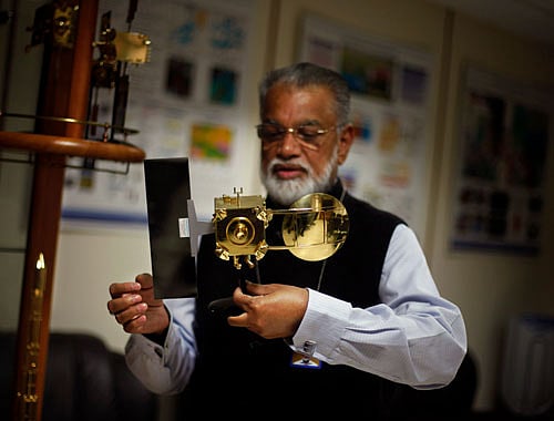 In this Thursday, Oct. 31, 2013 photo, Chairman of the Indian Space and Research Organization (ISRO) K. Radhakrishnan holds a model of Mars orbiter at his office in New Delhi. AP Photo.
