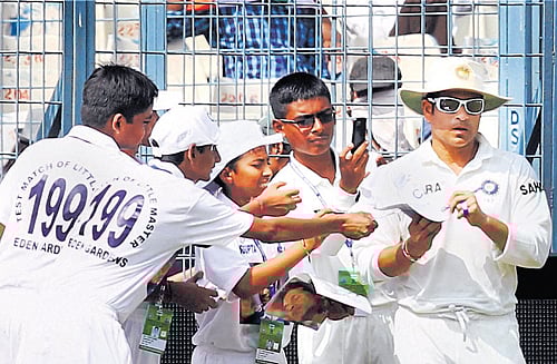 god's signature Sachin Tendulkar playing in his 199th Test, obliges ball boys' requests  for autographs at the Eden Gardens on Wednesday. pti