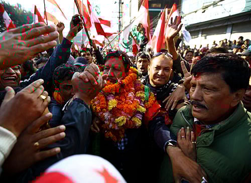 Supporters congratulate Rajan K.C. (C), candidate of party Nepali Congress, after he defeated Chairman of the Unified Communist Party of Nepal (Maoist) Pushpa Kamal Dahal, also known as Prachanda, from constituency number 10, in Kathmandu November 21, 2013. Nepal's powerful Maoists, trailing in this week's election, called for an end to vote counting on Thursday, risking further political instability in the small Himalayan nation. The ballot will elect an assembly, which will act as parliament, and draft a constitution aimed at ending years of instability which has seen five governments in as many years. REUTERS
