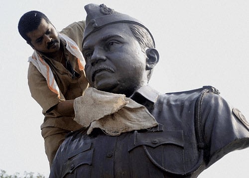 A worker cleans a statue of 26/11 terror attacks martyr Tukaram Omble in Mumbai on the eve of the fifth anniversary of the gruesome incident on Monday. PTI Photo