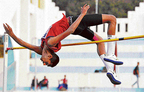fine performances: Shashidhar Harshith (left) leaps to the boys under-20 high jump gold. DH Photo