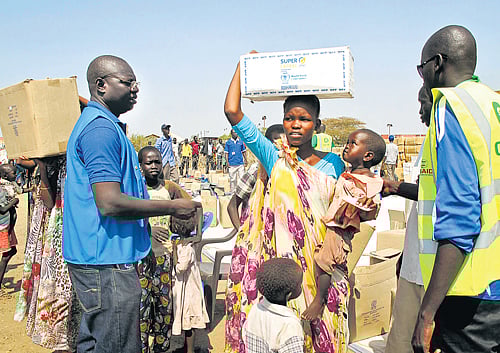 seeking help: A displaced woman and child receive food assistance from workers of WFP and non-governmental organisations in Juba, South Sudan on Tuesday. AP