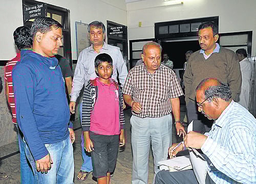 A railway officer enquires R Ramamurthy, elder son R Anil and grandson Chirag on their arrival at the railway hospital.