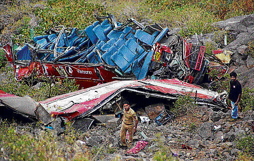 The wreckage of a bus lies at the site of an accident after it fell into a gorge about 160 km northeast of Mumbai on Thursday. AP