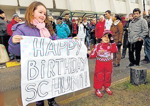 In the hearts of millions: Kids hold a banner wishing Michael Schumacher Happy Birthday as the German continues his recovery at a hospital in Grenoble, France. Reuters