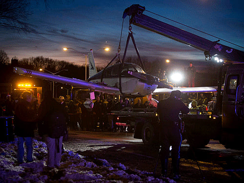 A single engine plane is lifted onto a flat bed truck after landing on Major Deegan Expressway in the Bronx borough of New York January 4, 2014. The small plane made an emergency landing on the New York City expressway on Saturday, resulting in minor injuries to the three onboard and backing up a traffic on the major thoroughfare, emergency officials said. The plane had departed Danbury, Connecticut, for a look of the Statue of Liberty and was on its way back when it experienced an onboard emergency, according to the New York City Office of Emergency Management. The three persons in the plane were treated at the scene for minor injuries and then transported to a nearby hospital for further evaluation, officials said. REUTERS