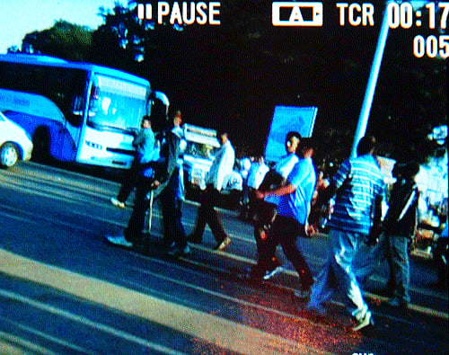 Video Grab - A group of Border Security Force (BSF) personnel coming out from Lalbagh Botanical Garden premises after attacking on duty Police including private security force and public, at Kengal Hanumanthaiah Circle entrance in Bangalore on Sunday.