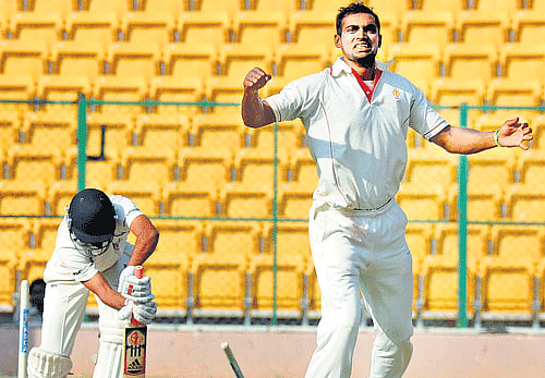 timber rattled: Karnataka's Abhimanyu Mithun celebrates after dismissing UP's Amit Mishra. dh photo / Srikanta sharma R