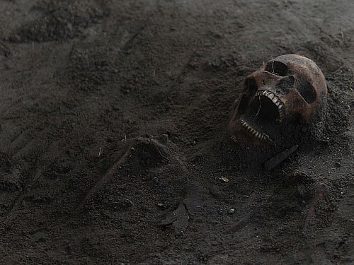 A human skull is seen at a construction site in the former war zone in Mannar, about 327 km (203 miles) from the capital Colombo, January 16, 2014. The discovery of a mass grave containing more than 30 skulls in northern Sri Lanka has fuelled speculation that there may be many more like it containing the remains of thousands who went missing during the island nation's nearly three-decade war. The remains, which workers stumbled on as they dug up roadside paving for a water project, are yet to be identified. The first mass grave to be found in the former war zone, it is spread over an area measuring about 400 square feet (37 square metres) and is 5 feet (1.5 metres) deep. Picture taken January 16, 2014. REUTERS