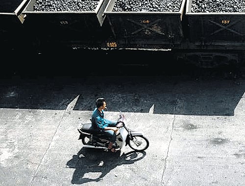 Dismal scene: Coal in Vietnam that is bound for China. A United Nations draft report says more is spent globally on subsidising fossil fuels than on shifting to cleaner energy. Reuters