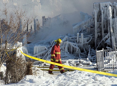 A firefighter walks past the rubble where fire destroyed a a seniors residence in L'Isle-Verte, Quebec, Thursday, Jan. 23, 2014. The fire raged through the seniors' residence, killing at least three people and leaving about 30 unaccounted for. The massive fire in the 52-unit complex broke out around 12:30 a.m. in L'Isle-Verte, about 140 miles (225 kilometers) northeast of Quebec City. AP Photo