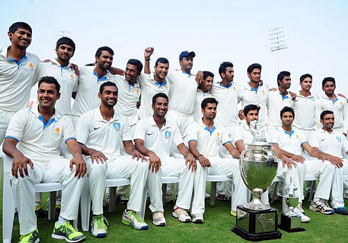 Sitting From Left - Stuart Binny, Abhimanyu Mithun, Vice Captain C M Goutham, Captain R Vinaykumar, Manish Pandey, Srinath Arvind, Robin Uthappa (Standing From Left) Ganesh Satish, R Samarth, Abrar Kazi, Shreyas Gopal, Mayank Agarwal, H S Sharath, Karun Nair, K L Rahul, Ronit More, Amit Verma, Kunal Kapoor, and K P Appanna pose with Ranji Trophy soon after winning the Final match against Maharastra Ranji team on 2nd innings of 5th day play at Rajivgandhi International Cricket Stadium at Uppala, in Hyderabad on Sunday. DH