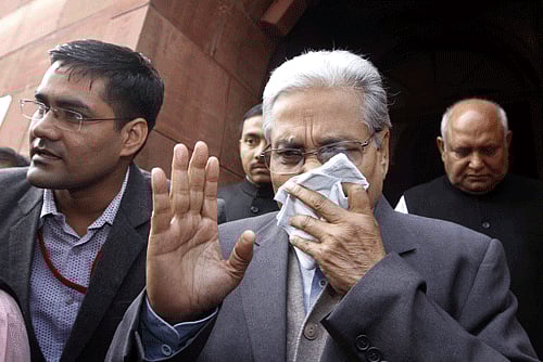 An MP covers his face with a handkerchief after being affected by pepper spray gas in New Delhi, Thursday, Feb. 13, 2014. Congress party lawmaker L. Rajagopal from Andhra Pradesh sprayed pepper spray inside Parliament on Thursday from the main speaking zone, creating chaos that left his colleagues coughing and crying as they were ushered from the hall, in a protest over a long-contentious proposal to create a new southern state of Telangana from the existing Andhra Pradesh. (AP Photo)