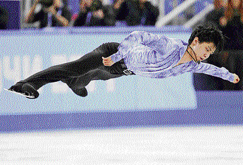 brilliant: Japan's Yuzuru Hanyu performs en route to the gold in figure skating at Sochi. Below:&#8200;Hanyu reacts after his world record score is flashed on the screen. AP