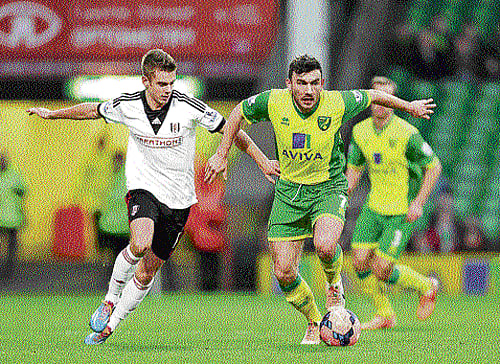 tense times: Norwich City's Robert Snodgrass (right) battles for the ball with Fulham's Alex Kacaniklic. Norwich is among the teams battling relegation. ap