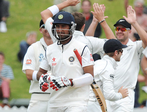 Cheteshwar Pujara is out for 17 off the bowling of New Zealand's Tim Southee on the final day of the second test at the Basin Reserve in Wellington, New Zealand, Tuesday, Feb. 18, 2014.  New Zealand win the two-Test series 1-0 after the second and final match against India ended in a draw here today. AP