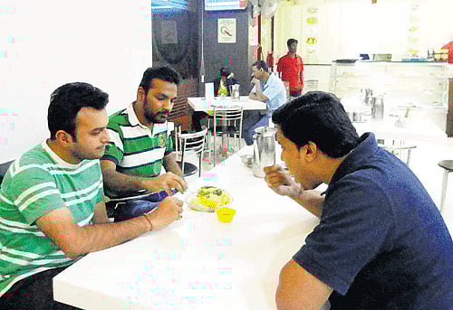 relishing: Customers enjoying a meal.