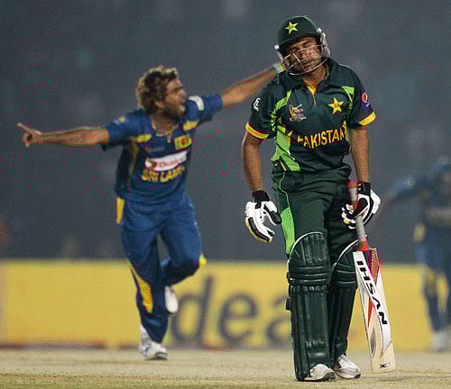 Pakistan's Bhatti reacts as Sri Lanka's Malinga celebrates his dismissal during their ODI cricket match for the Asia Cup 2014 in Fatullah