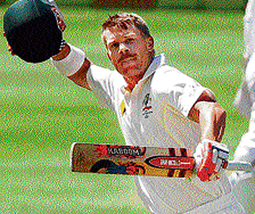 brutal knock : Australia's David Warner exults after  completing his century on Saturday. reuters