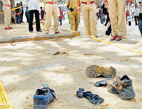 Police inspect the spot of explosion in Kalasipalya on Monday. dh Photo