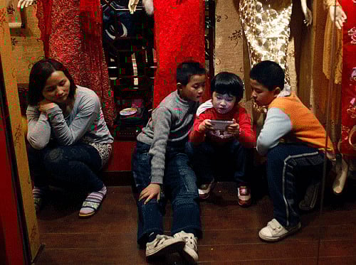 Do you often play games, check emails or respond to office calls on your cell phone while with family on a dinner? This phone addiction can damage your emotional bonding with kids soon. Reuters file photo for representation only