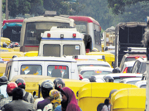 stuck An ambulance caught in traffic congestion. DH Photo by BK Janardhan