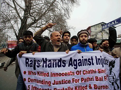 Jammu and Kashmir state lawmaker Engineer Abdul Rasheed, center, shouts slogans during a protest against the killing of a teenage boy in government firing, in Srinagar, India, Saturday, March 15, 2014. Thousands of mourners in the troubled Indian portion of Kashmir defied a curfew Saturday and buried the Kashmiri teenage boy who was shot dead by government forces, police and witnesses said. (AP Photo)