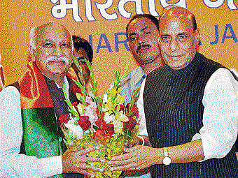 BJP president Rajnath Singh welcomes noted journalist  M J Akbar who joined the party in New Delhi on Saturday. PTI