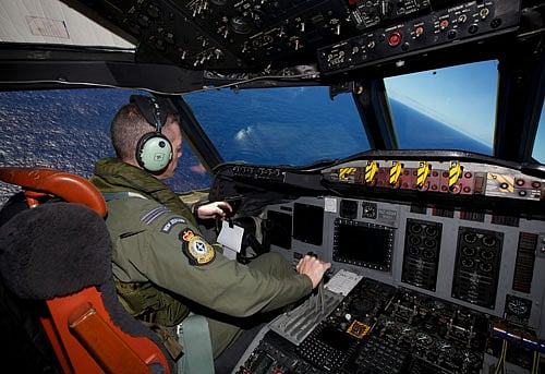 Captain Flt. Lt. Tim McAlevey of the Royal New Zealand Air Force flies a P-3 Orion in search for the missing Malaysia Airlines Flight 370 over the Indian Ocean, Friday, April 11, 2014. Authorities are confident that signals detected deep in the Indian Ocean are from the missing Malaysian jet's black boxes, Australian Prime Minister Tony Abbott said Friday, raising hopes they are close to solving one of aviation's most perplexing mysteries. Abbott told reporters in Shanghai that crews hunting for Flight 370 have zeroed in on a more targeted area in their search for the source of the sounds, first heard on Saturday. AP