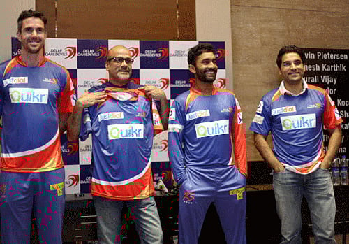 Delhi Daredevils captain K Pietersen (ext left) along with team CEO Hemant Dua and vice captain Dinesh Karthik at the unveiling of their new jersey in New Delhi. PTI Photo