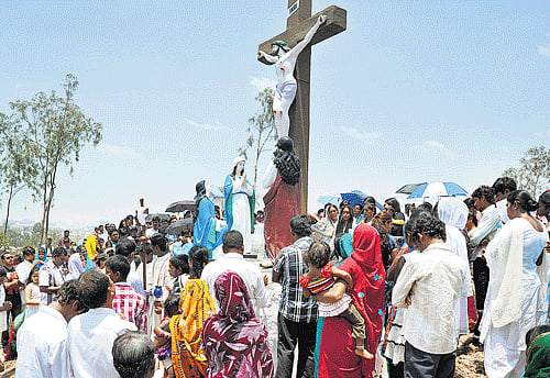 People gather atop a hill at Our Lady of Lourdes Church in Whitefield. DH photo