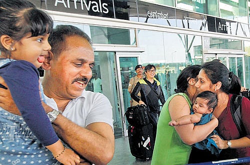 Relatives receive passengers of MH192 at the KIA in Bangalore on Monday. PTI