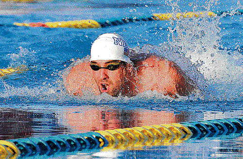 making splashes: Legendary Michael Phelps competes in the 100M butterfly race on Thursday. reuters