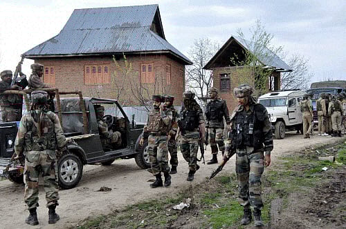 Army personnel near the house where Lashkar-e-Toiba militants were hiding during an encounter, in Shopian on Friday. PTI Photo