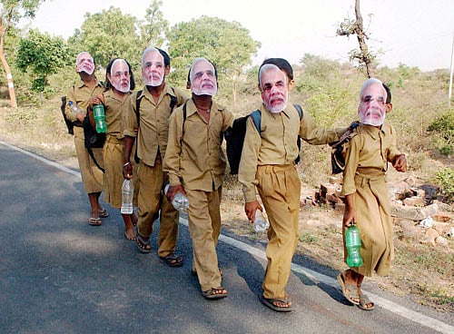 In the holy town of Devprayag, where rivers Bhagirathi and Alaknanda join to become Ganga, a massive poster of Narendra Modi watches over visitors, while Congress flags adorn several shops in the market beside Har ki Pauri (The steps of Lord Shiva) in Hardwar. PTI File Photo