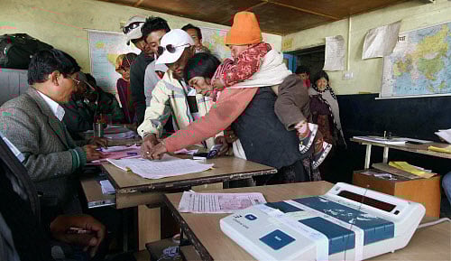 Tribal woman casting her vote at highest polling station of India, 'Hikkim Village' situated at 15500ft in Lahoul, Himachal Pradesh on Wednesday. PTI Photo