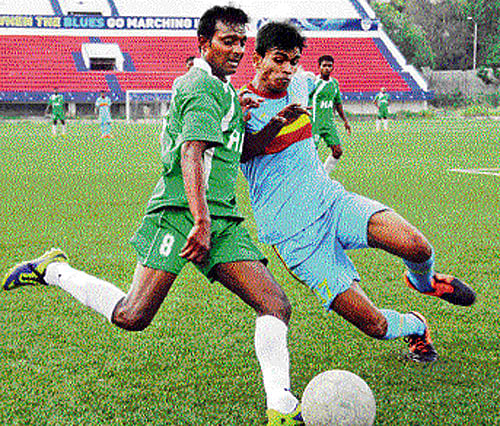keen contest: HASC's Xavier Vijay Kumar (left) and Rajib Dev of ASC vie for the ball on Wednesday. DH Photo