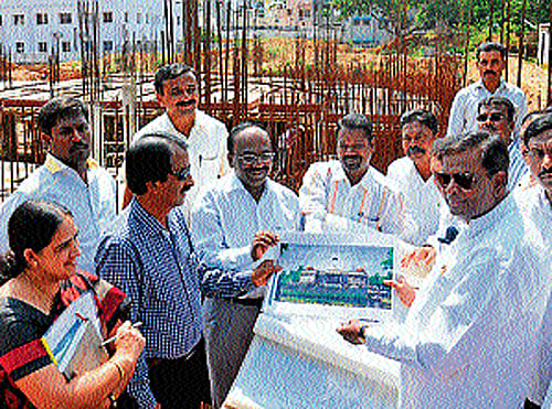 Revenue and District in-charge Minister V Sreenivas Prasad inspects the works of Dr B R Ambedkar Bhavan, in Mysore, on Wednesday. MLA Vasu, and others are seen. DH PHOTO