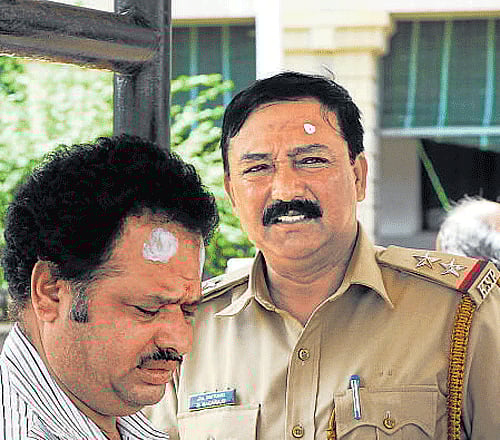 Clerk Loknath and SI Nagaraj.