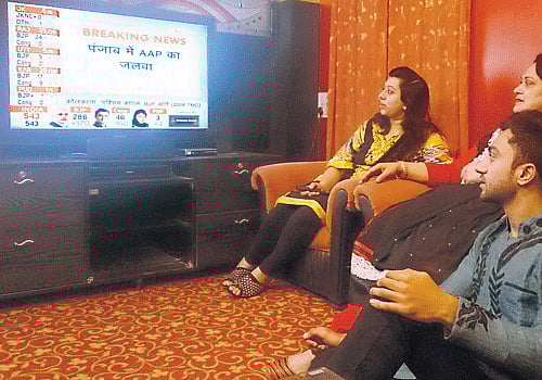 interested: From left: Arfa Samreen, Abida Anees and Aqib Faraaz following the updates on television.