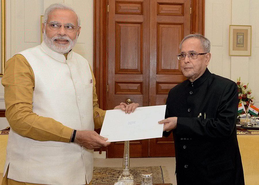 President Pranab Mukherjee hands over to Narendra Modi the letter appointing him as Prime Minister at Rashtrapati Bhavan in New Delhi on Tuesday. PTI