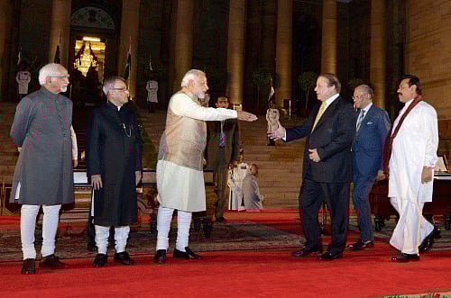 Prime Minister-elect Narendra Modi is greeted by Nitin Gadkari during the BJP parliamentary party meeting at the Central Hall of Parliament in New Delhi on Tuesday. PTI Photo