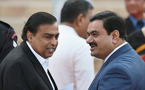 File photo of Industrilaists Mukesh Ambani (left ) and Gautam Adani at the swearing-in ceremony of the NDA government at Rashtrapati Bhavan in New Delhi. PTI.