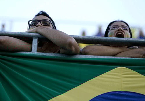 Spectators watch the first half of the World Cup opening match between Brazil and Croatia in group A at Itaquerao Stadium in Sao Paulo, Brazil, AP photo