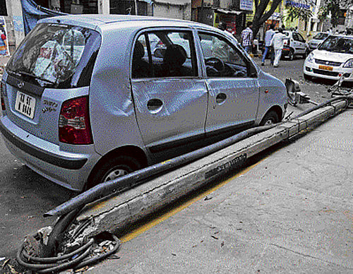 Windy rain triggers tree falls and damage to electricity poles, endangering lives of road-users, besides disrupting power supply.