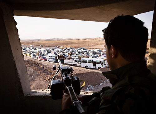 Original An Iraqi security forces member with his weapon takes position as people, who fled from the violence in Mosul, arrive at a camp for internally displaced people on the outskirts of Arbil. The government is exploring options to evacuate nearly 100 Indians stranded in the Iraqi cities of Mosul and Tikrit, which have fallen to the advancing militants of a jihadist organisation linked to al-Qaeda. Reuters