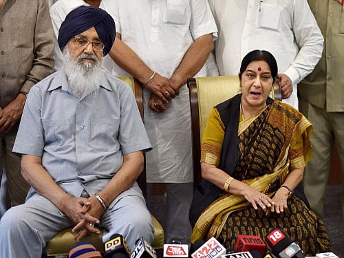 External Affairs Minister Sushma Swaraj with Punjab Chief Minister Parkash Singh Badal addresses the media after meeting with the families of some of the Punjabi workers abducted in Iraq, in New Delhi. PTI Photo